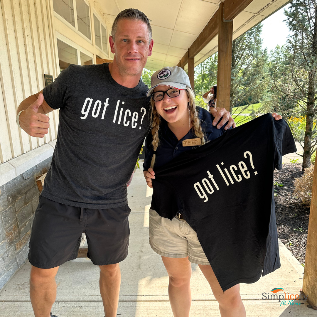How to check for head lice at summer camp - Pete the Lice Guy and a camp nurse smiling while holding a 'got lice?' t-shirt.
